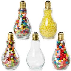 several glass vases filled with different types of candy