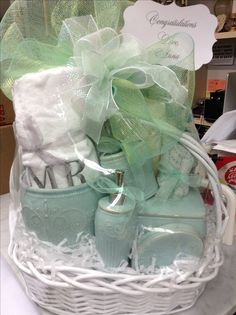 a white basket filled with baby's shoes and personalized gifts for someone special