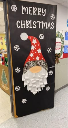 a christmas door decorated with an image of a gnome and snowflakes on it