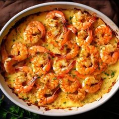 a dish filled with shrimp and grits on top of a table