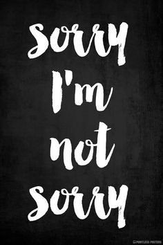 the words sorry i'm not sorry written in white ink on a black background