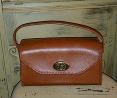 THIS IS A BEAUTIFUL VINTAGE 50'S ERA LEATHER HANDBAG ,BROWN WITH BROWN WHIP STITCHING,BRASS TURN LATCH CLOSURE.CLOTH  LINED.MEASURES 6" TALL X 10" LONG AND 4" DEEP.NO MARKINGS,NO LEATHER WEAR,A VERY COOL UNIQUE HANDBAG.SMOKE FREE HOME.SEE MORE GREAT VINTAGE BAGS IN MY STORE! SHIPPING IN US 12.65 CANADA 25.00 OVERSEAS PRIORITY INSURED 65.00 Vintage Crossbody Satchel With Detachable Handle, Vintage Crossbody Satchel For Formal Occasions, Vintage Formal Crossbody Satchel, Vintage Evening Crossbody Satchel, Vintage Brown Satchel Bag, Mid-century Brown Satchel Bag, Mid-century Brown Shoulder Bag, Vintage Brown Handheld Bag, Vintage Brown Satchel For Everyday Use