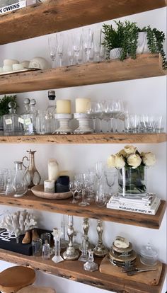 the shelves are filled with glassware and candles