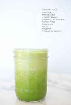 a green smoothie in a mason jar on a marble counter top with the recipe below it