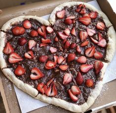 a heart shaped pizza with chocolate and strawberries on it