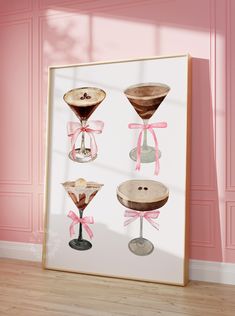 three martini glasses with pink ribbons on them are displayed in front of a pink wall