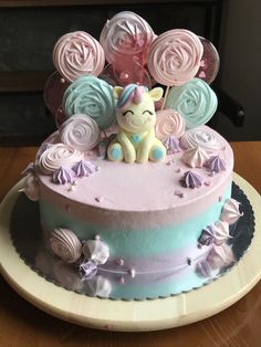 a cake decorated with pastel icing and flowers