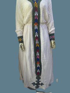 Fetel dress from axum Tigray Ethiopia. It's hand woven from an organic cotton and hand embroidered. The dress is very graceful and can be worn for a wedding, christening and holidays.  Please add your measurements when placing your order.  Since it's hand embroidered it takes about a month to make unless we have a ready-made one in your size delivery might take 4-6 weeks. White Dresses With Weaving Work For Traditional Ceremonies, White Folk Dress With Weaving Work, Folk Style Dresses With Weaving Work For Traditional Ceremonies, Traditional White Handwoven Dress, Ceremonial White Handloom Dress, Bohemian Ceremonial Dresses With Woven Motifs, White Folk Dress With Woven Motifs, White Bohemian Ceremonial Dress, White Bohemian Dress For Ceremonial Use