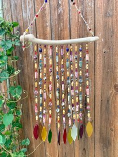 a wind chime hanging from a wooden fence