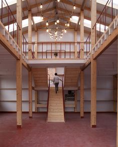 a man is walking up the stairs in an empty building