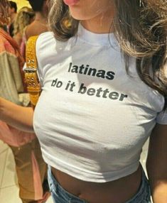 a woman wearing a t - shirt that says latinas do it better on her chest