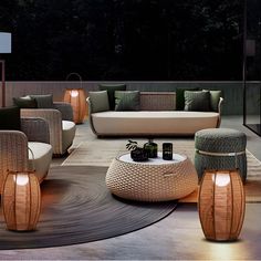 an outdoor living room with wicker furniture