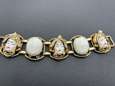 This is a stunning and iconic Selro Selini Asian Princess Bracelet. It has 3 links with gold tone, white lucite and faux pearl Asian Princess faces and two links with white lucite 'stones'. Selro bracelets were often unsigned as it's this one, but it shows all the signs of the original especially with the rivet detail on the back. The front of the bracelet is in very good vintage condition with minor wear but the back does show wear and tear so that the gold tone metal has rubbed off and this is Collectible White Bracelet Jewelry, Collectible White Metal Jewelry, Princess Bracelet, Asian Princess, Princess Face, Lucite Bracelets, Wedding Jewelry Bracelets, Jewelry Lookbook, Bracelet Vintage