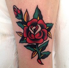 a red rose tattoo on the leg