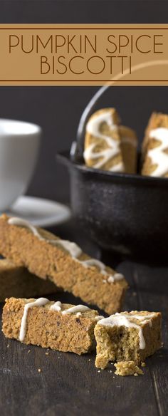 pumpkin spice biscotti is cut in half and placed on a table with a bowl of oranges