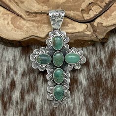 This Exquisite Sterling Silver Cross Pendant By The Acclaimed Mixtec Artist Federico Jimenez Features Six Natural Soft Green Turquoise Cabochons, Most All With A Delicate Matrix And Bezel-Set Atop A Scalloped Frame Adorned With Intricate Decorative Stampings. The Bale Showcases Crescent And Circle Stampings, Enhancing Its Unique Design. The Center Back Of The Cross Is Stamped With Federico’s Hallmark And Sterling, Affirming Its Authenticity. With A Total Length Including The Bale Of 3.75” And A Width At The Widest Point Of Nearly 2.25”, This Pendant Weighs 37 Grams. Purchased Directly From Federico Himself, It Embodies The Artist’s Exceptional Craftsmanship. Please Note: The 8mm Ste Scalloped Frame, Turquoise Cross Pendant, Turquoise Cross, Sterling Silver Cross Pendant, Silver Cross Pendant, Cross Jewelry, Sterling Silver Cross, Green Turquoise, Silver Cross