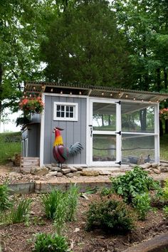 a small chicken coop in the middle of a garden