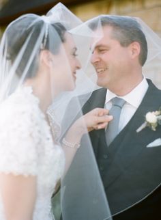 the bride and groom are looking into each other's eyes