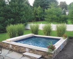 a small swimming pool in the middle of a yard