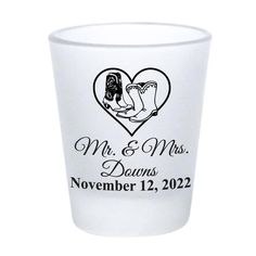 a shot glass with the words mr and mrs written on it, in black ink