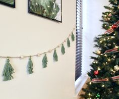 a christmas tree is decorated with green tassels