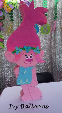 there is a paper cut out of a pink troll