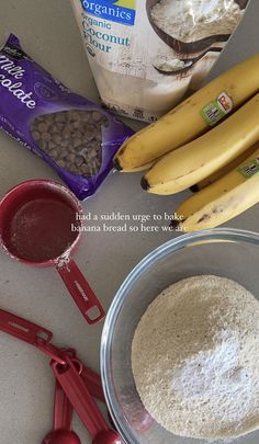 ingredients to make banana bread sitting on a counter next to bananas and measuring spoons