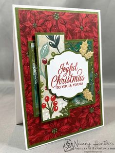 a handmade christmas card with poinsettis and holly on the side,