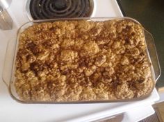 a casserole dish sitting on top of a stove next to a burner