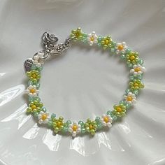 "Handmade Beaded Bracelet 🍵 ✿ Made with glass seed beads and metal accents ✿ Matcha green, milky white, yellow, and sea foam green ✿ The bracelet has 1.5\" of extension chain" Green Beaded Chain Bracelet For Gift, Green Beaded Bracelet For Gift, Green Beaded Bracelets With Round Beads, Green Beaded Chain Bracelets For Jewelry Making, Green Beaded Chain Bracelets As A Gift, Green Beaded Bracelet With Round Beads, Green Beaded Chain Bracelet For Jewelry Making, Green Beaded Chain Bracelet As Gift, Green Round Bead Jewelry For Spring