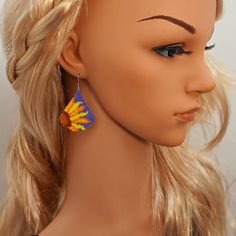 a close up of a mannequin head wearing earrings