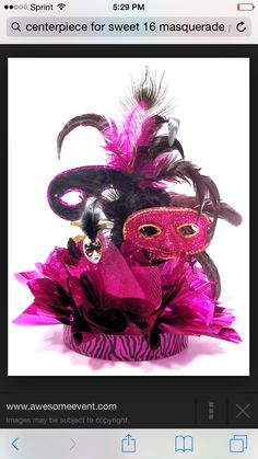 a masquerade mask with purple feathers and pink flowers on the bottom is featured in an instagram