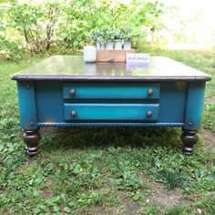 a blue coffee table sitting in the grass