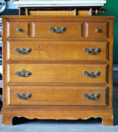 an old wooden dresser with many drawers and knobs on it's top shelf