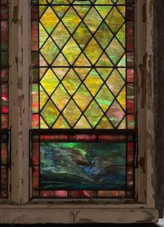 a stained glass window in the corner of a building