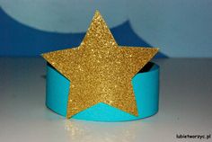 a blue and gold paper crown with a star on it