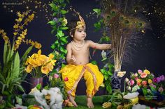 a young child dressed in yellow is surrounded by flowers and feathers