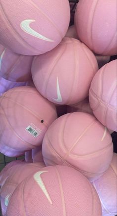 pink nike basketballs are stacked up in a pile and ready to be used as balls