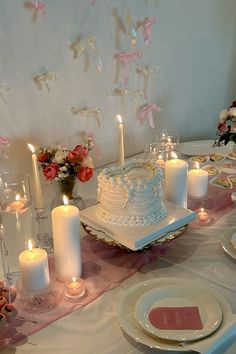 a table topped with lots of white candles