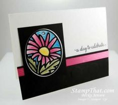 a close up of a greeting card with a flower on the front and pink ribbon at the bottom