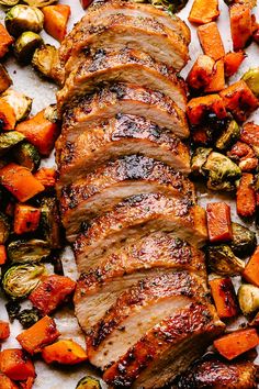 sliced pork and roasted vegetables on a sheet of parchment paper