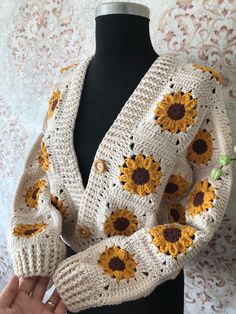 a crocheted sweater with sunflowers on it