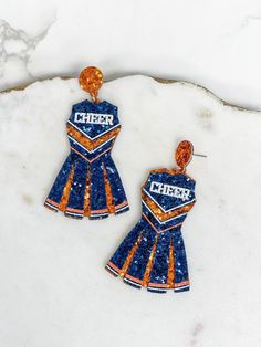 Show your team spirit with this pair of Glitter Cheerleader Dress Dangle Earrings.2"LLead & Nickel Compliant Cheer Earrings, Team Spirit, Cheerleading, Dangle Earrings, Glitter, Navy, Orange