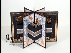 an open book with some paper cut out of it and butterflies on the pages, in front of a white background