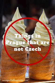 two donuts with white frosting in front of a red circle that says things in prague that are not czech