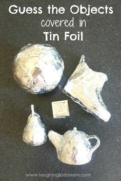 three pieces of tin foil sitting on top of a black surface with the words guess the objects covered in tin foil