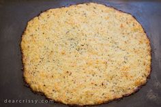 an uncooked pizza sitting on top of a baking sheet in a frying pan