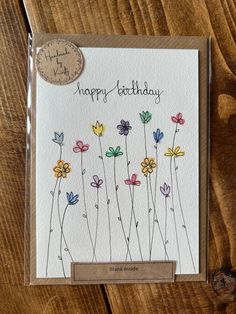 a happy birthday card with colorful flowers on it