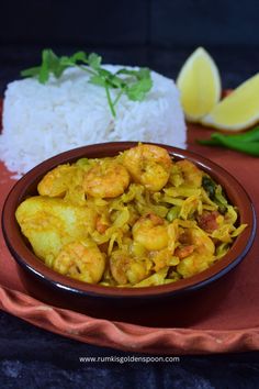 a bowl filled with food next to rice and lemon wedges on a red plate