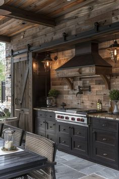 an outdoor kitchen with wooden walls and flooring